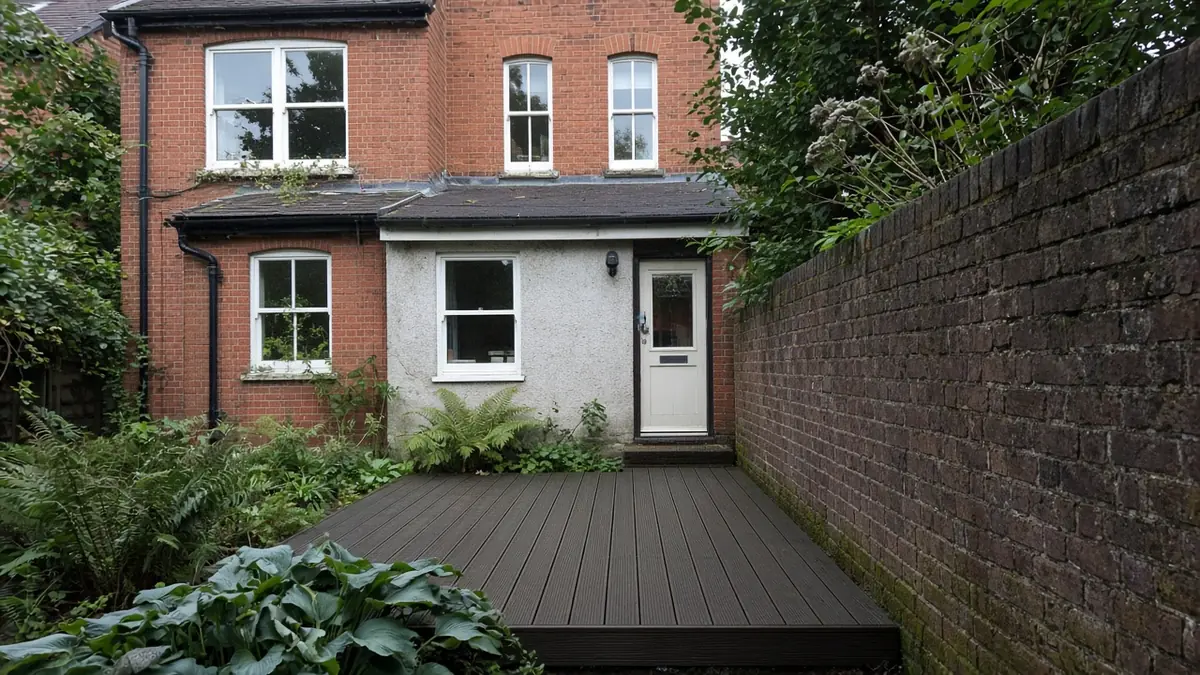 Example image: dark oak composite deck in a shady corner of a Victorian terrace garden